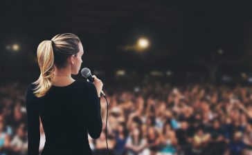 Donna con microfono su palco pubblico