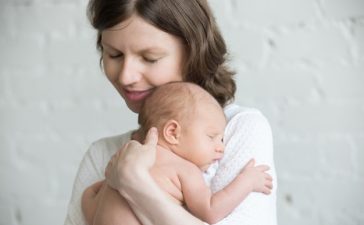 mother-baby-cuddled_1218-549